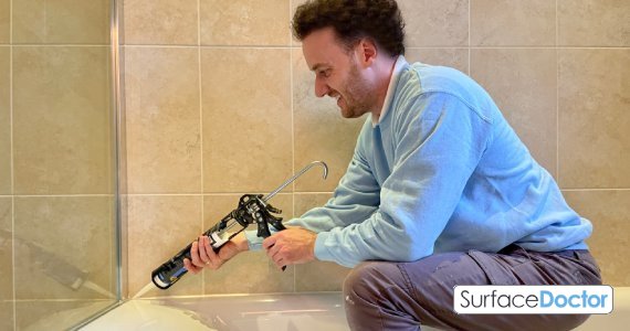 Mastic man sealing structural glass in Leatherhead commercial buildings