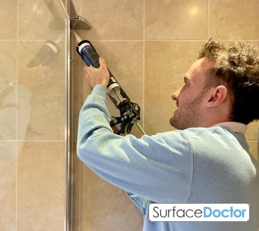 Mastic man sealing structural glass in Leatherhead commercial buildings